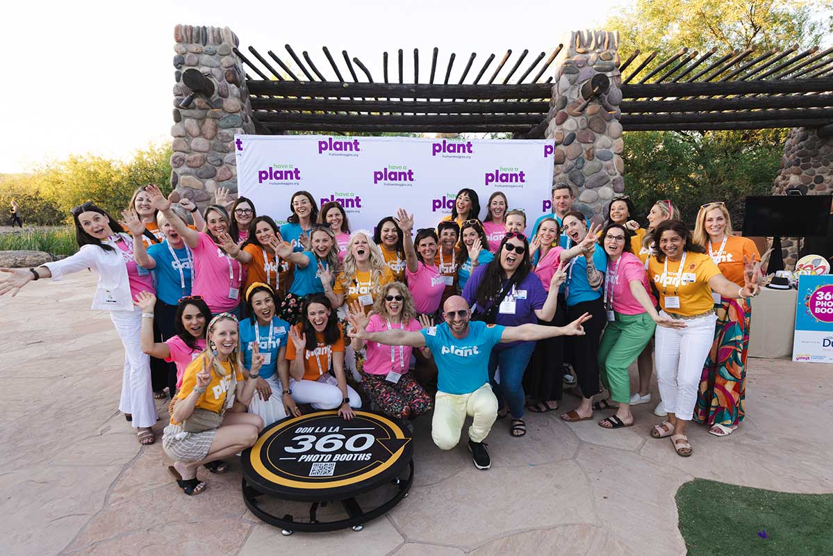 A group of attendees from the 2024 Consumer Connection event pose in a "wild way" at the social media photo booth.