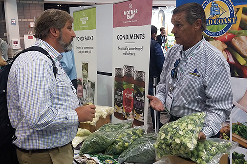 Man showing brussel sprouts to customer